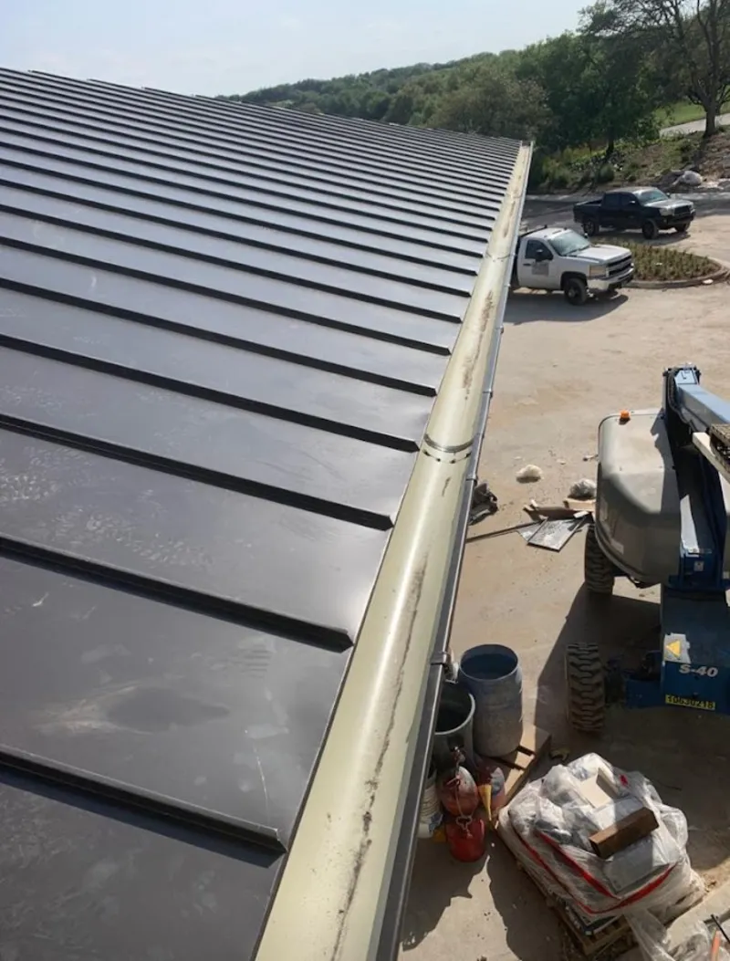 Standing seam panel and gutter detail on a metal roofing jobsite in Columbiana